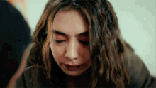 a close up of a woman with her eyes closed