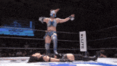 a woman in a wrestling ring with a sign that says ' live ' on it