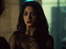 a woman with a tattoo on her neck is wearing a black top