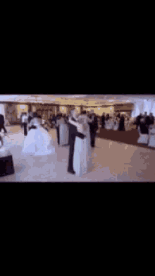 a group of people are dancing in a room