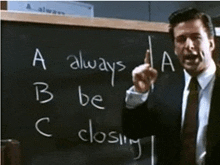 a man stands in front of a chalkboard that says a always b be c closing
