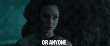 a woman in a dark room with the words `` or anyone '' written on the screen .