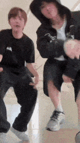 a couple of young men are dancing together on a staircase .