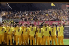 a group of baseball players in yellow uniforms with the number 1 on their shirts