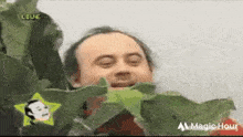 a man is eating a leaf with his eyes closed and a star in the background .