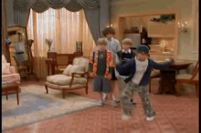 a group of kids are dancing in a living room