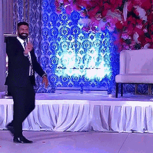 a man in a suit is standing on a stage