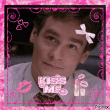 a picture of a man with a bow on his head and the words kiss me on it