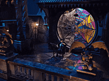 a stained glass window with a spider web in the middle
