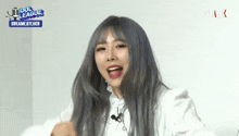 a girl with gray hair and red lips is wearing a white shirt with the words idol league dreamcatcher on it