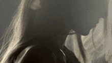 a close up of a woman 's neck and hair .