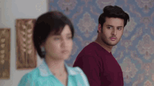 a man and a woman are standing next to each other