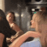 a blurry picture of a group of women dancing in a room