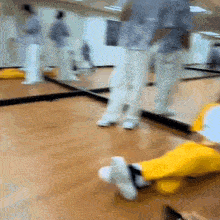 a person is laying on the floor in front of a mirror in a gym .