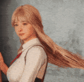 a woman with long blonde hair wearing a white shirt