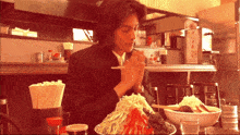 a man sitting at a table with a bowl of food and chopsticks