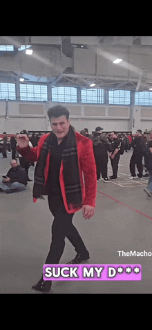 a man in a red jacket and black scarf says suck my d * * * *