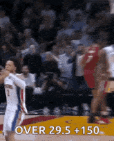 a basketball player with the number 2 on his jersey is jumping for a rebound