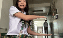 a girl in a school uniform has a lanyard with a name tag that says ' amanda ' on it