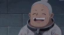 a man with chains around his neck is smiling in front of a wall with blood drops