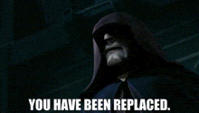 a man in a hooded jacket and tie is standing in the dark and says `` you have been replaced '' .