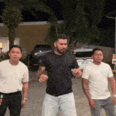 a man in a black shirt has a license plate that says nmd 1555