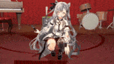 a girl is sitting on a stage with a microphone in her hand
