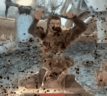 a man in a video game is being attacked by a giant