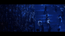 a man with his arms outstretched in front of a crowd