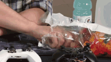 a bottle of gatorade sits next to a bag of gummy bears on a table