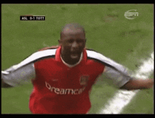a soccer player wearing a red dreamcast jersey
