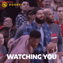 a group of people watching a basketball game with the words " watching you " in the corner