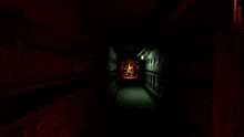 a dark hallway with a red light at the end of it