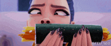 a woman with long black nails is eating a roll of food