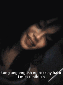 a woman is laying down with a caption that says kung ang english ng rock ay bato i miss u bibi ko