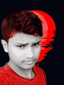 a boy in a red shirt looks at the camera with a red background