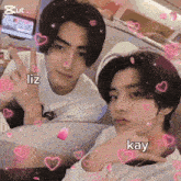 a couple of young men sitting next to each other with hearts around them and liz and kay written on the bottom right