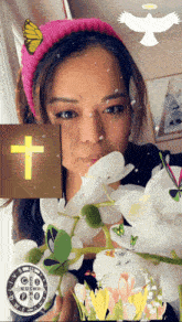 a woman in a pink headband is holding a cross