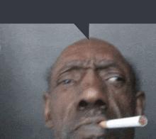 a man is smoking a cigarette with a speech bubble above him