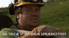 a man wearing a hard hat and headphones says da tru