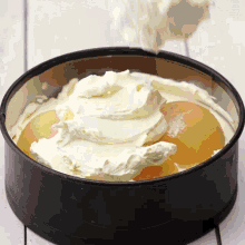 whipped cream is being poured into a cake