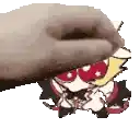 a hand is holding a cartoon character with red eyes and a hat .