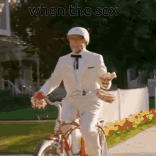 a man in a white suit is riding a bicycle with the words " when the sex " above him