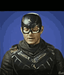 a man in a superhero costume with the word bas on the bottom right
