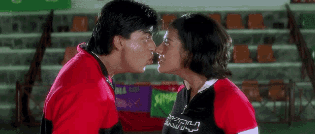 a man and a woman are kissing and the man is wearing a shirt that says kfrh