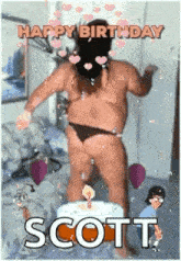 a man in a bikini is dancing in front of a cake with the name scott on it .