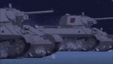 a group of tanks are driving down a snow covered road at night .