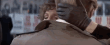 a man and a woman are hugging each other .