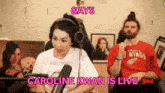 a man and a woman are sitting in front of a microphone with the words gays caroline kwan is live
