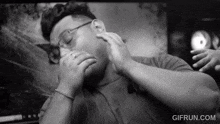 a black and white photo of a man with the website gifrun.com at the bottom right